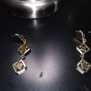 A pair of silver clip on earrings for woman